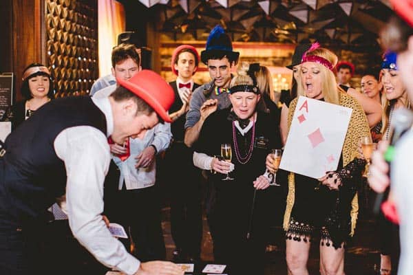 Gatsby Gamble horse race Guests cheering during a game at Gatsby themed party