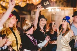 Guests bidding in an auction during a Gatsby themed event