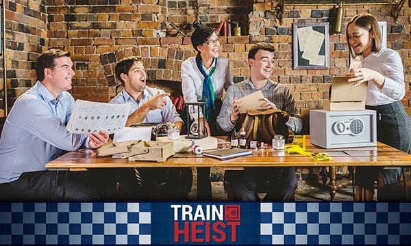 Train Heist logo with team doing team building activity