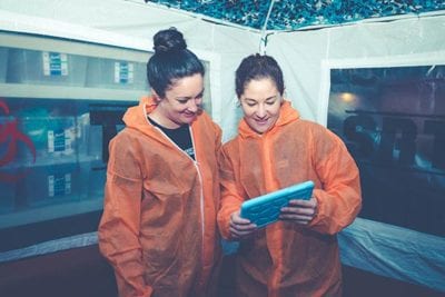 Players using a tablet in a military tent