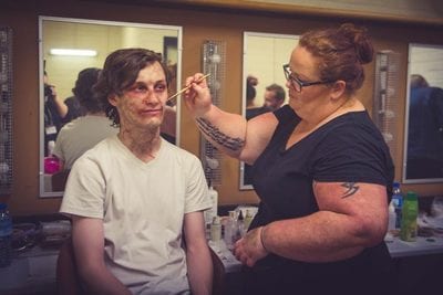 Actor getting zombie make up applied for Containment experience