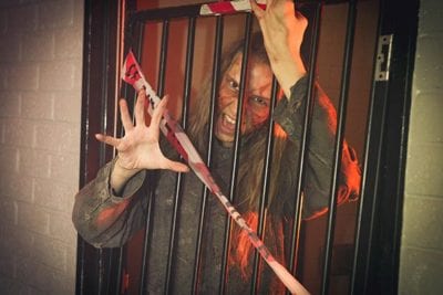 Zombie reaching through bars during Containment game
