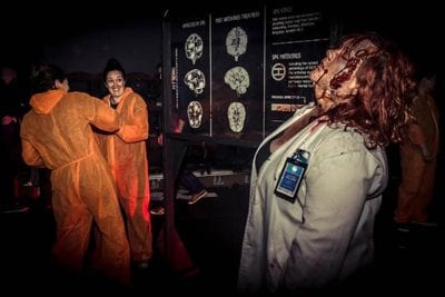 Containment brain panel Zombie scaring players in front of brain information