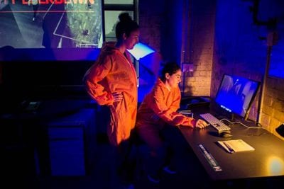 Containment office Players using a computer in lab during Containment game