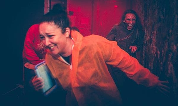 Containment gauntlet Player being chased by a zombie in a hallway during Containment game