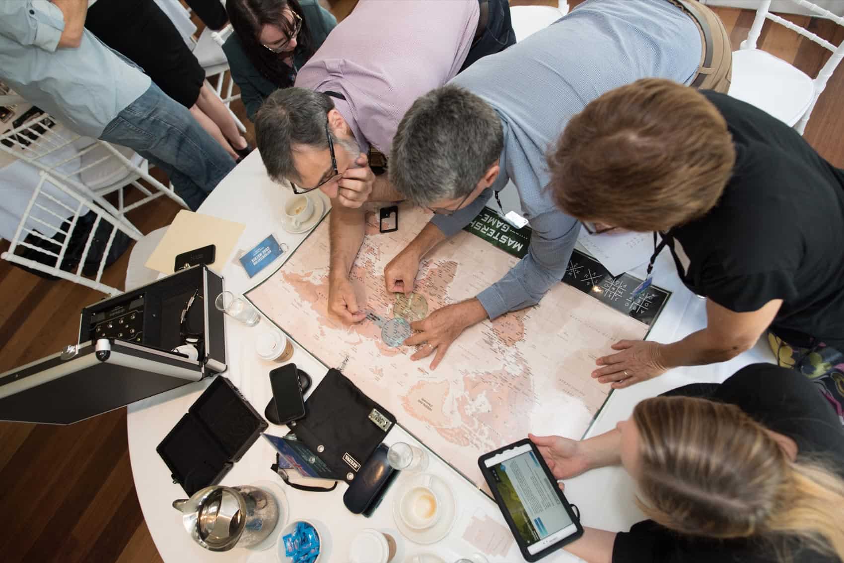 Players solving a spy puzzle during Mastership Game activity