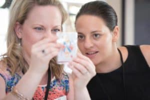 2 women solving a card puzzle during team building activity