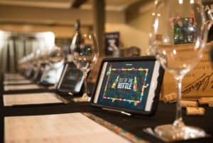Close up of tablet with Out of the Bottle game at wine tasting event