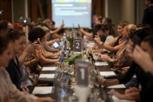 Table of guests taking selfies before wine tasting