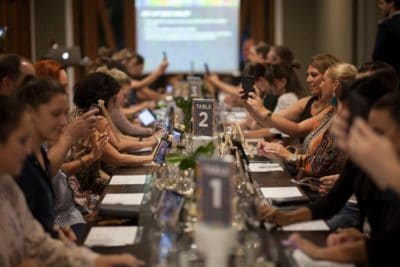 Out of the Bottle Table of guests taking selfies before wine tasting
