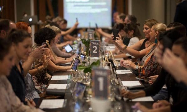 Out of the Bottle Table of guests taking selfies before wine tasting