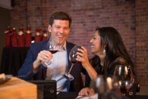 Guests laughing holding wine