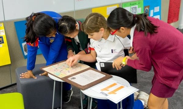 Group of girls solving puzzle during incursion activity