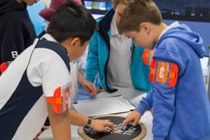 Group of boys solving maths problem in student incursion activity