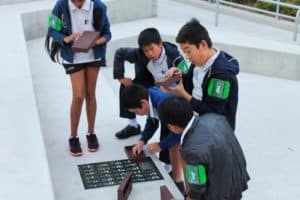 Students solving braille puzzle during team building activity