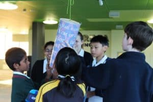 Students working on english puzzle during incursion