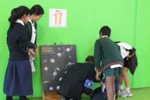 Team of students working on space themed puzzle