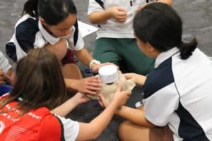 Students building a vessel for a water carrying challenge