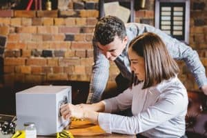 2 guests working on opening a safe during team activity