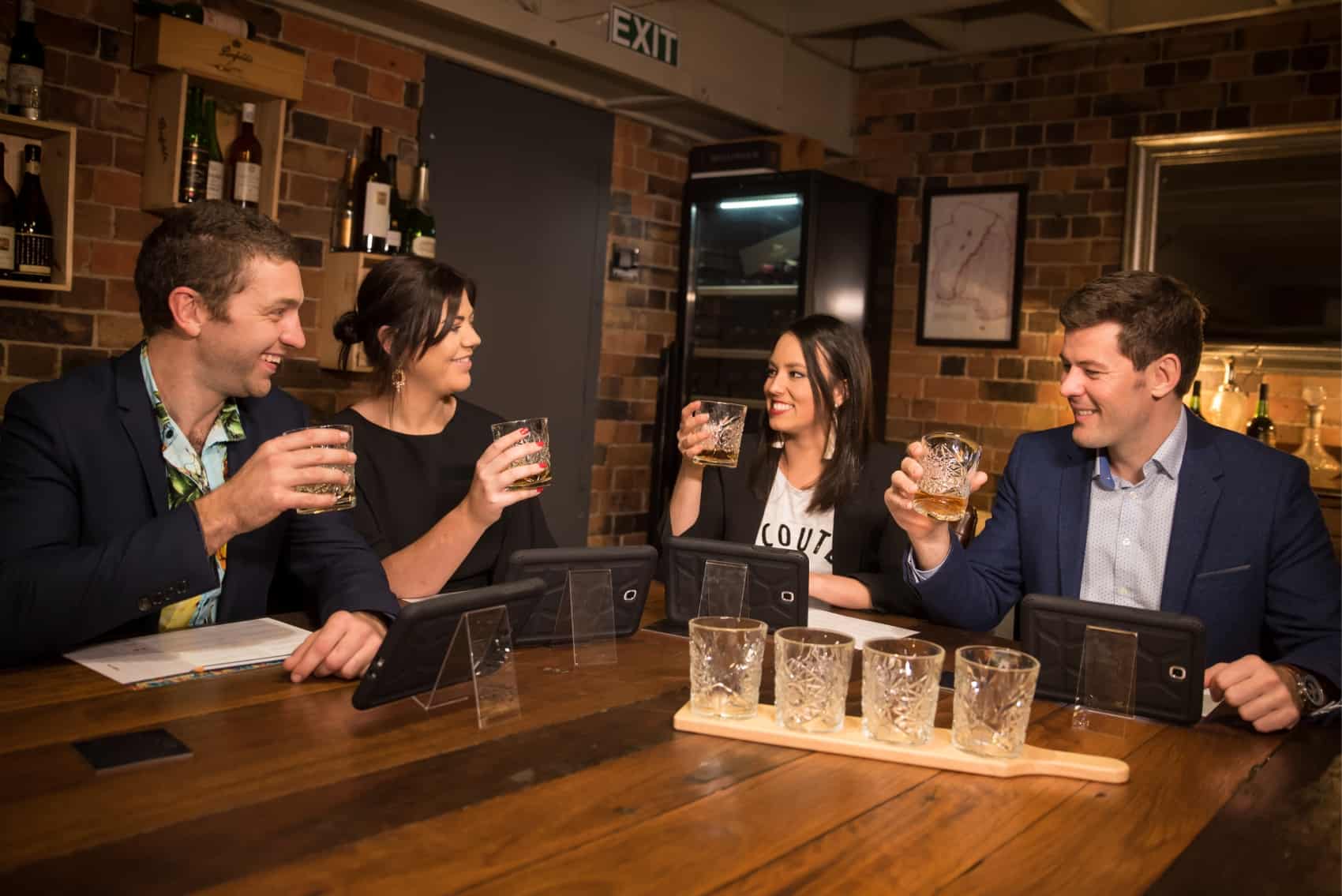 Guests cheering glasses during whiskey tasting event