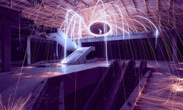 Sparklers glowing purple in abandoned warehouse