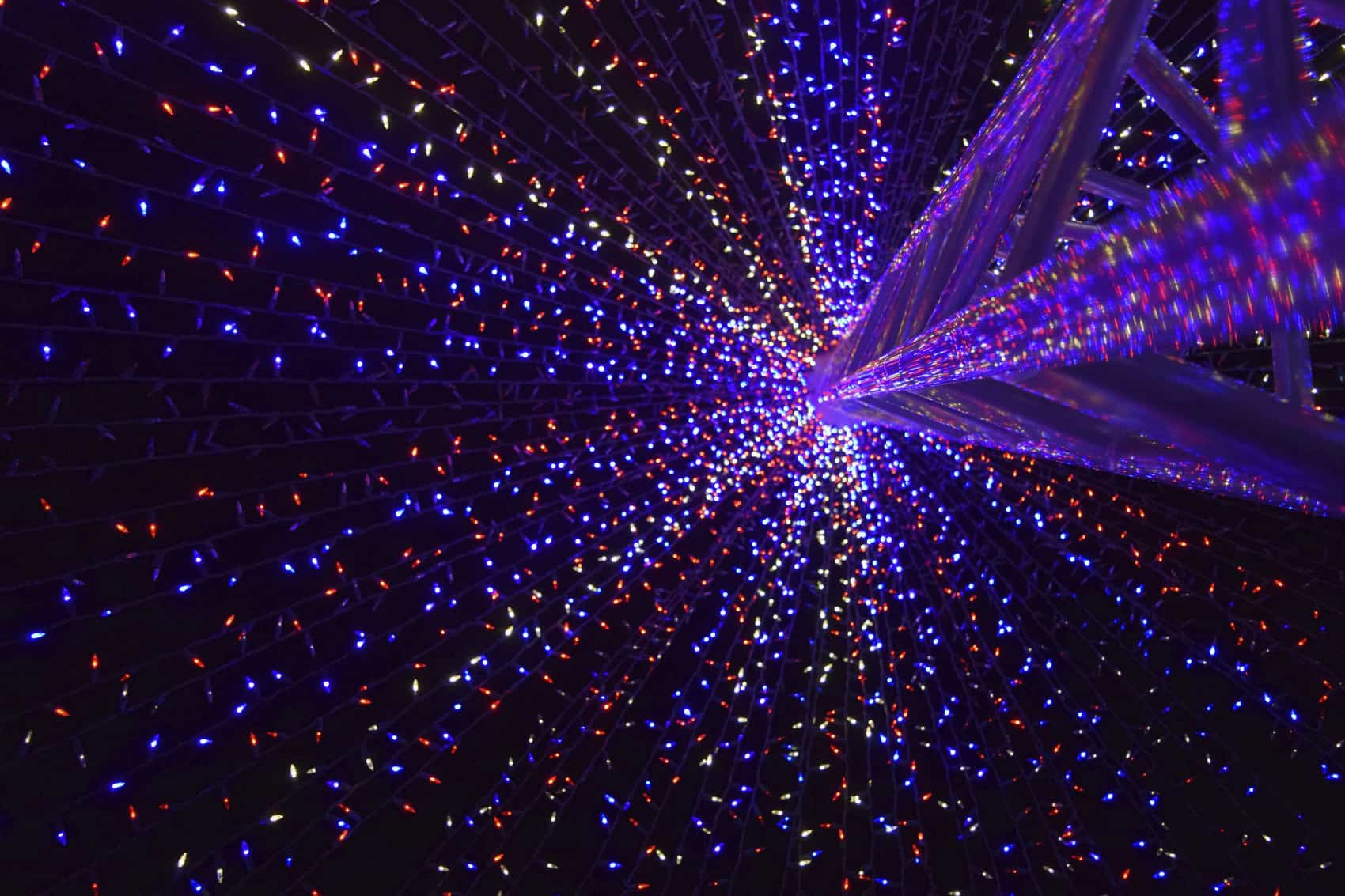 Blue and purple fairy lights hanging from a pole