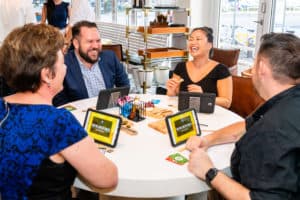 Guests laughing while eating cheese during food tasting