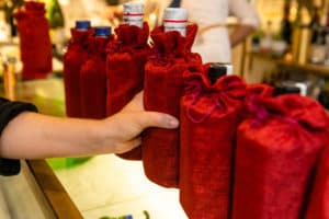 Close up of bottles of gin in red covers during tasting