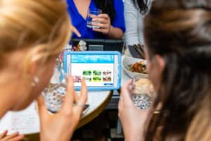 Close up of guests using app during gin tasting