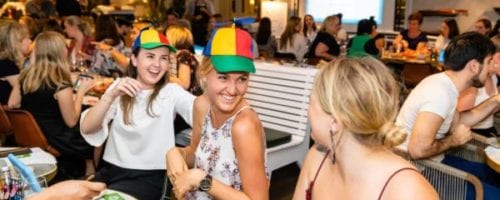 Team bonding hats 2 guests wearing helicopter hats and laughing