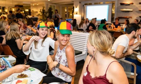 Team bonding hats 2 guests wearing helicopter hats and laughing