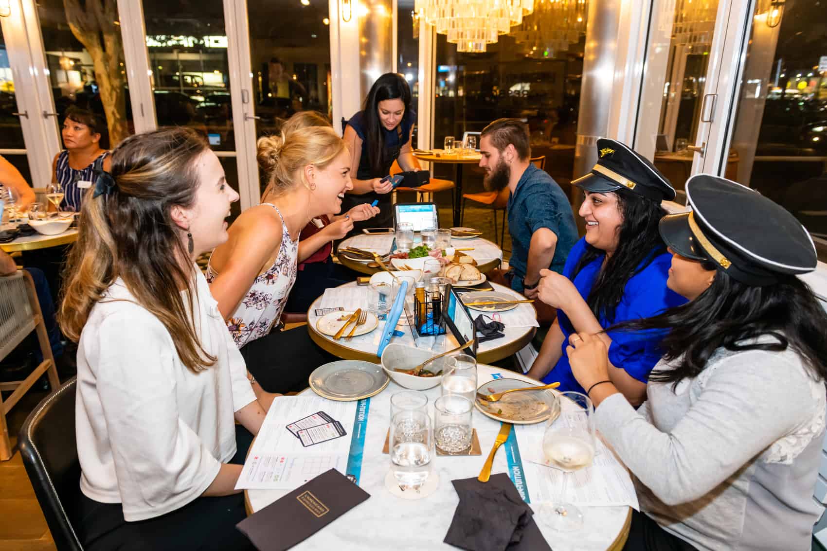 Table of guests laughing during gin tasting