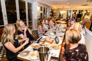 Guests laughing at a tablet during gin tasting experience