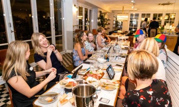 Guests laughing at a tablet during gin tasting experience