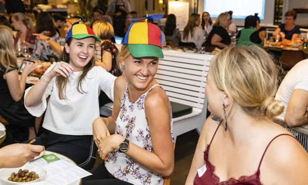 Entertainment hats Women wearing helicopter hats and laughing during entertainement event
